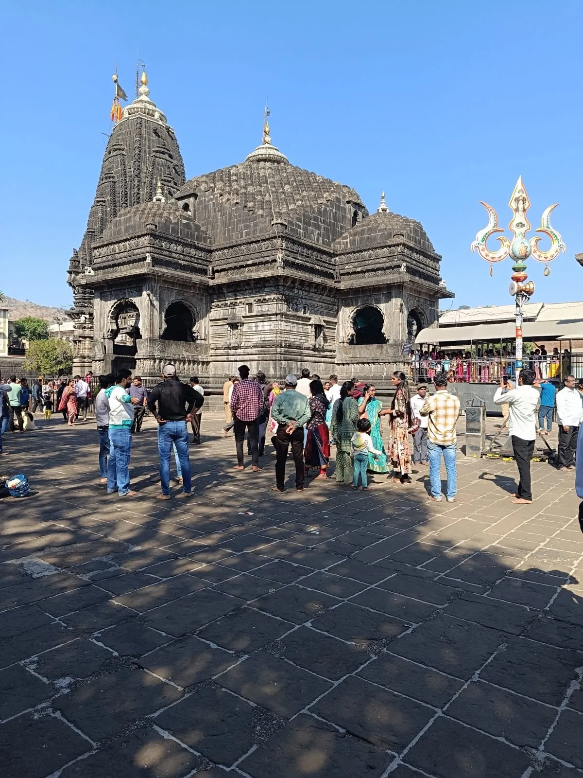Trimbakeshwar temple in Nashik district, with visitors standing in its stone courtyard
